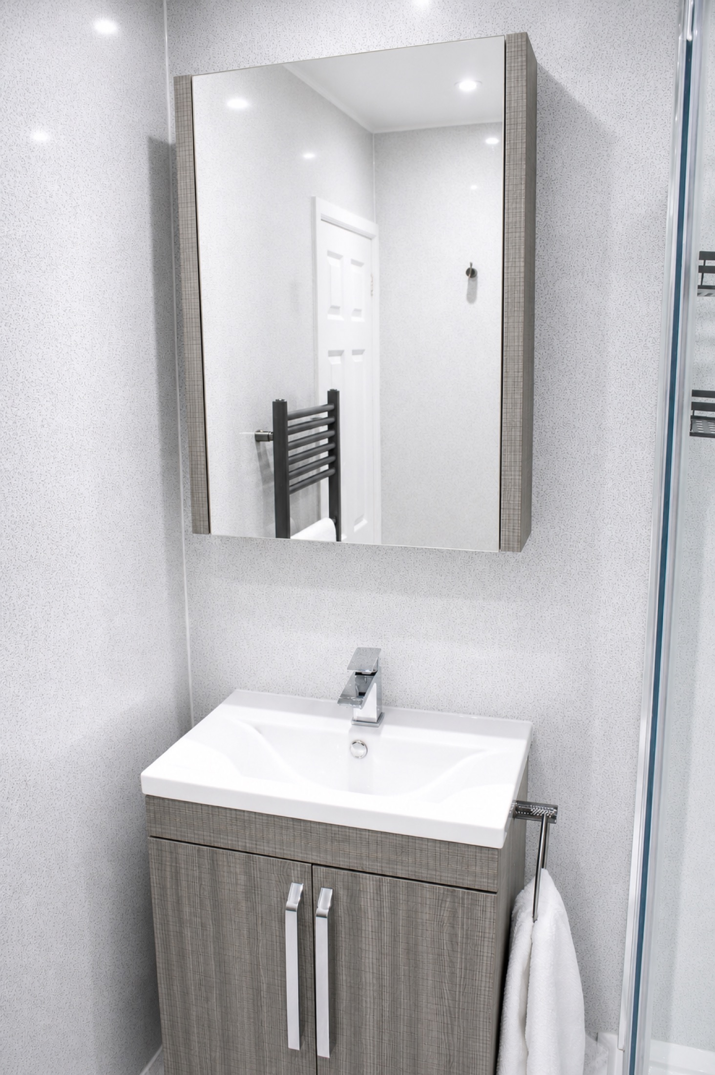 Bathroom vanity and mirror in the 4 bedroom serviced home near Liverpool